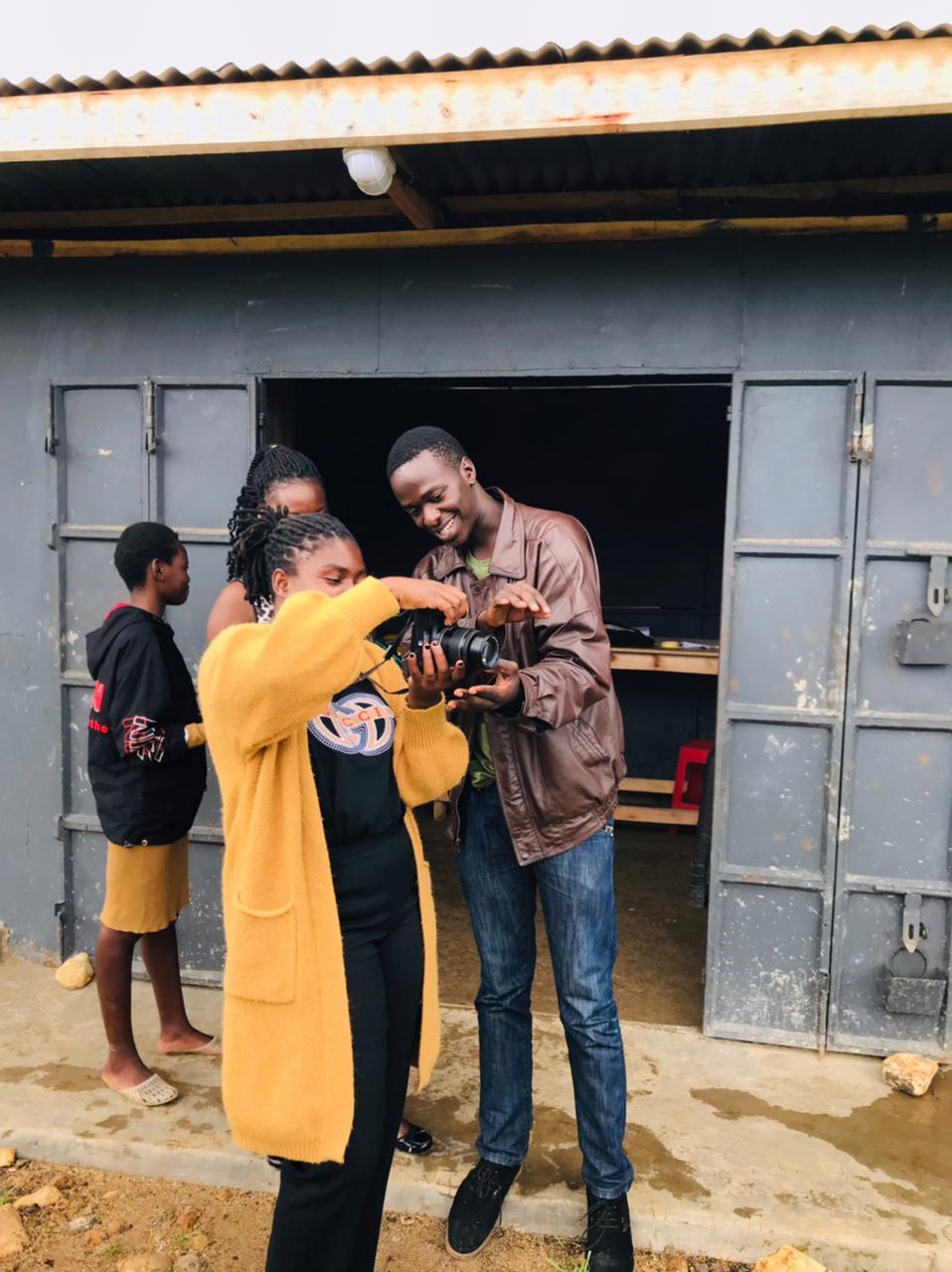 Two Ganjisha students practising camera skills outdoors